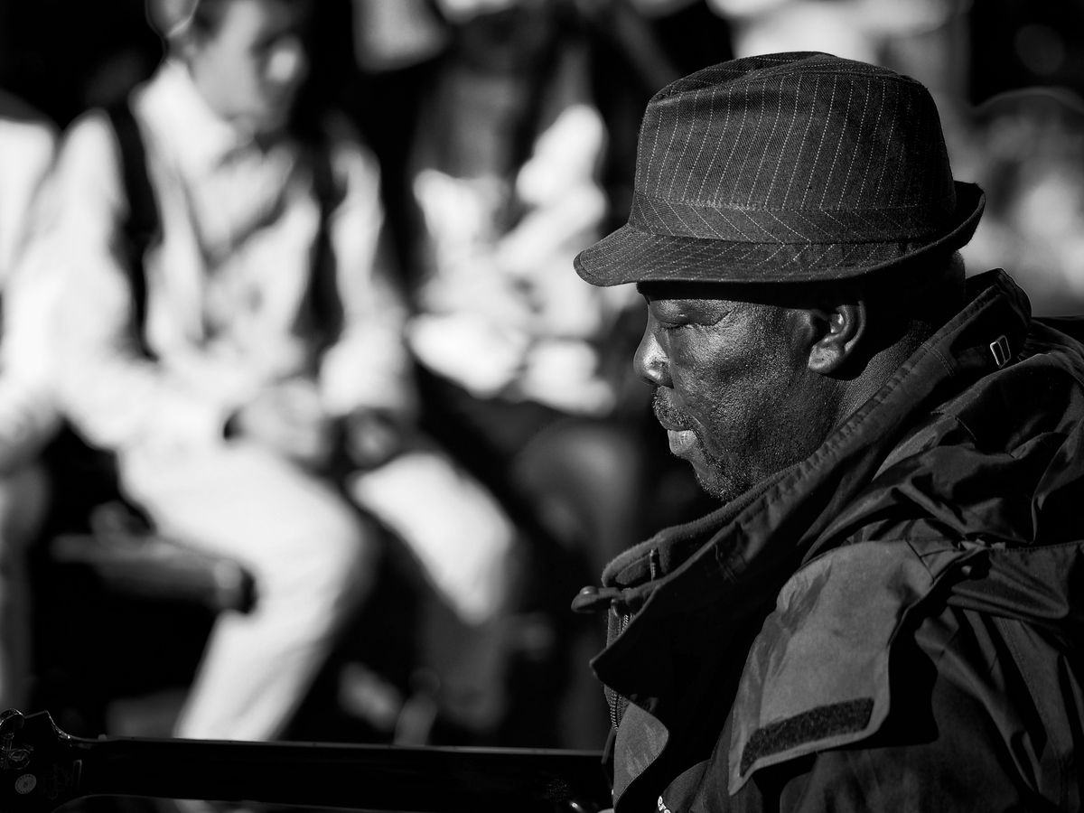 Guitarist playing to a croud in the street in Canterbury