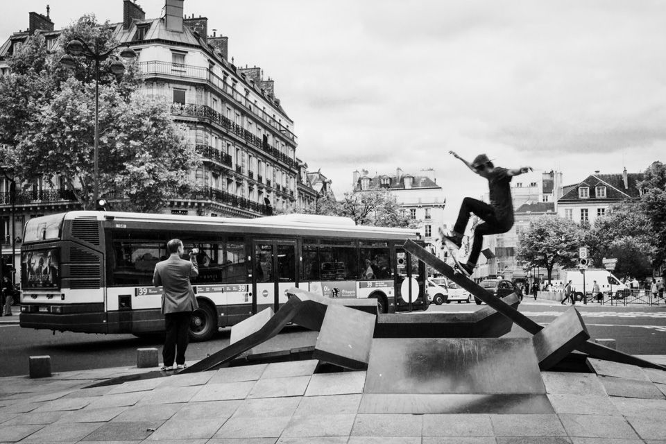 Skater using street art in Paris.