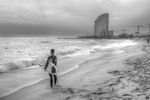 Making some pictures in Barcelona beach side I look at the position of the surfer with the surf that was the same of the building. They were both challengin the storm. I decided to use B&W.